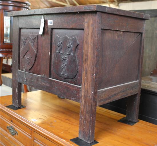 Reproduction oak coffer, with heraldic shield-carved panelled front